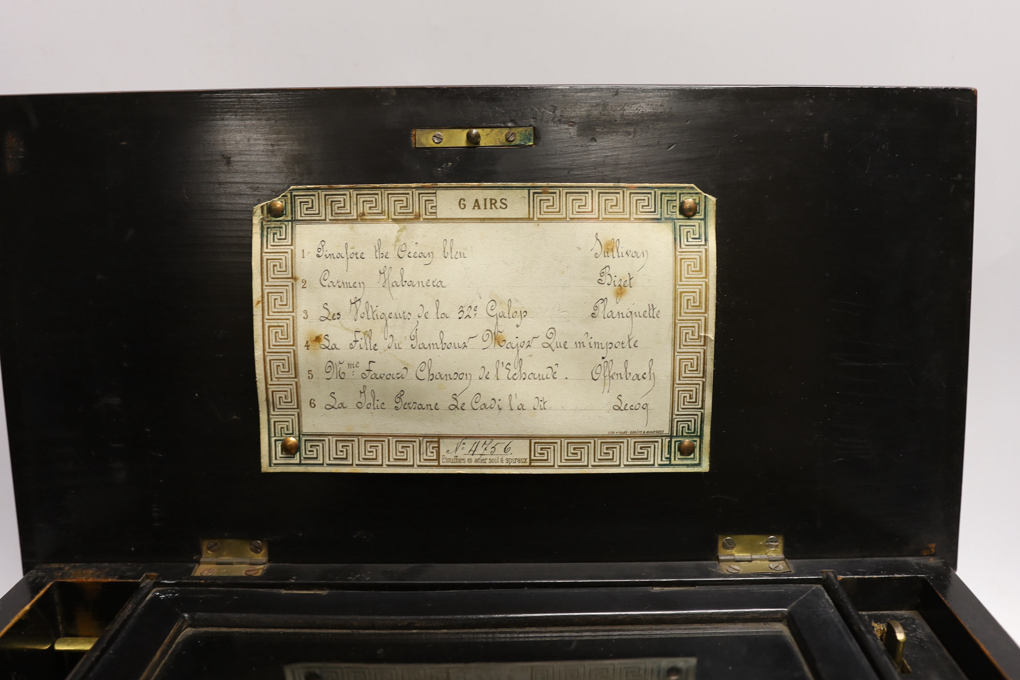 An inlaid rosewood cased musical box, single cylinder with a 56 note comb (one tooth broken and missing) playing six airs, tune list on underside of lid, 35 x 13 x 17.5cm